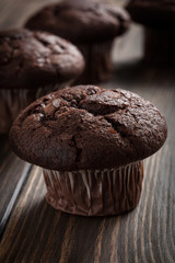 Chocolate cake muffins on a table. Dark lighting