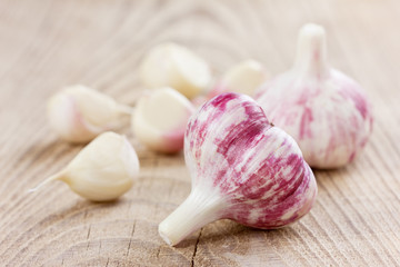 garlic whole and cloves on a wooden rustic background