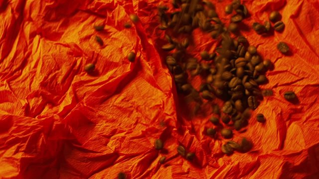 Coffee beans on the red surface
