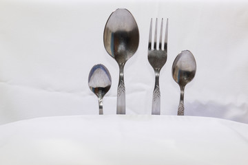 Spoons and forks, small spoons on a white background