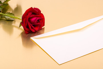 perfect red rose and an envelope on a gold background