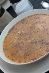 Chitterlings with marjoram soup in white bowl.