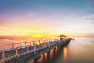 Fototapeta premium Landscape of Wooded bridge in the port between sunrise