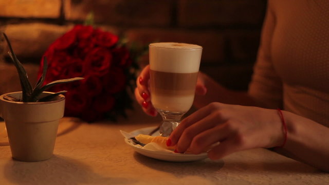 woman drinking coffee latte in a cafe