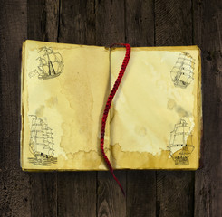 Old book with sailing ships drawings