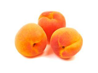 Ripe orange apricots, peaches isolated on white background.