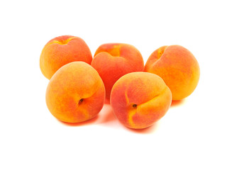 Ripe orange apricots, peaches isolated on white background.