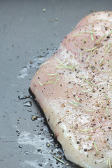 Raw piece of chicken breast.