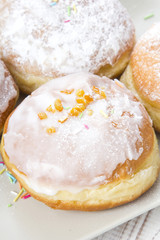 donuts with frosting and powdered sugar on a platter