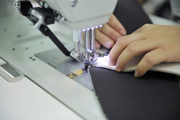 Dressmaker Working On Sewing Machine