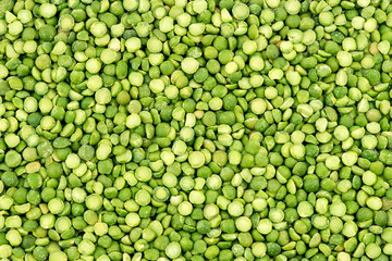 Macro background texture of vibrant green split peas