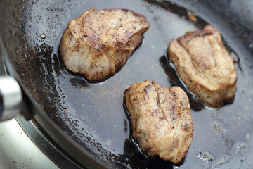 Pieces of cured pork fried on wok.