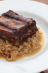 Pork ribs glazed and roasted, served on sauerkraut.