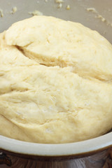Bowl full of dough ready for rolling.