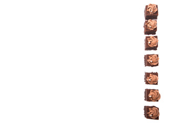 Bite sized chocolate cake with icing on top over white 