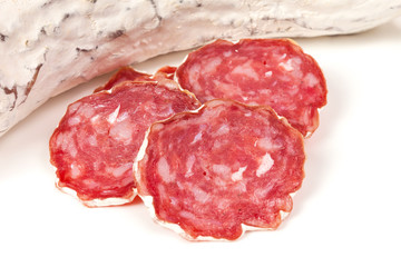 pile of red salami, on a white