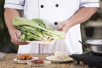 Chef present vegetable with noodle ingredient