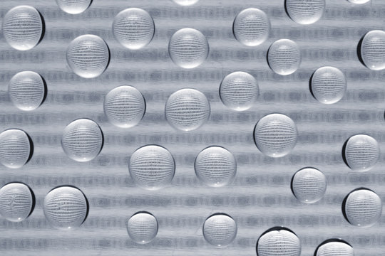 binary code through water drops on glass