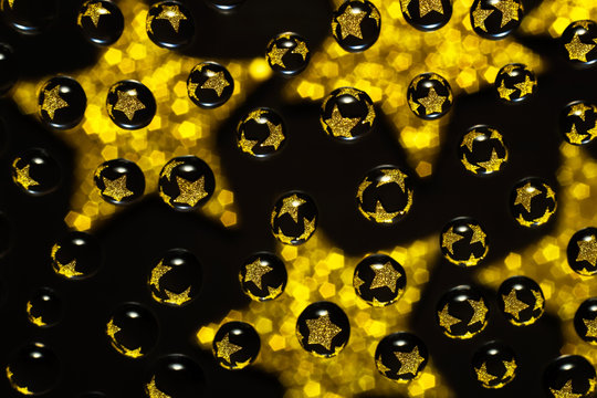 water droplets with reflections of golden stars