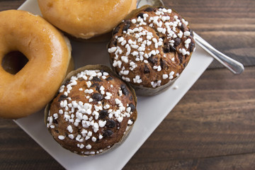 Two stacked sugared donuts and muffins