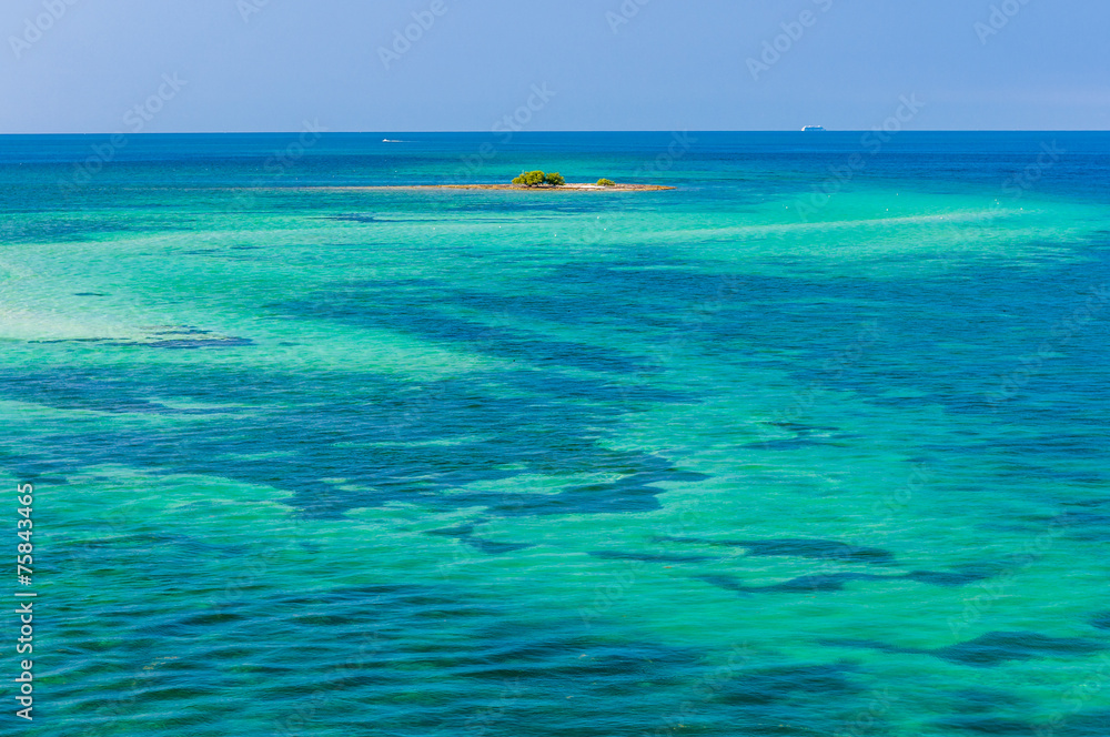 Wall mural water of tropical sea and tiny coral reef on background