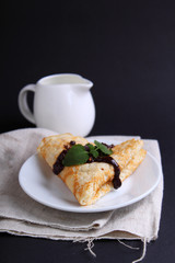 pancakes with chocolate decorated with mint leaf
