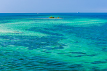 Water of tropical sea and tiny coral reef on background