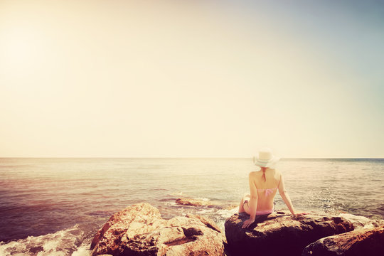 Young Woman Sunbathing On Rocky Beach. Vintage