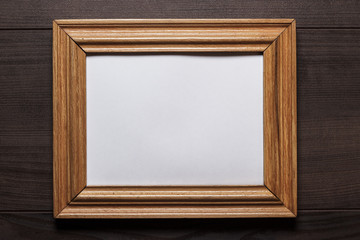 old empty frame on wooden wall