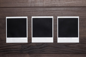 Fototapeta premium old photos on brown wooden table background