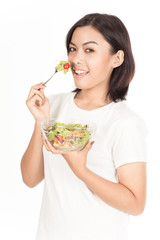 Pretty girl eating fresh vegetable salad