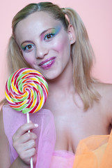 Sweet Greek girl holding a lollipop heart