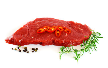 Piece of fresh raw meat with chili pepper, rosemary over white