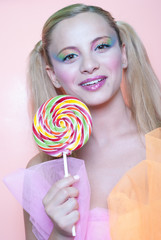 Sweet Greek girl holding a lollipop heart