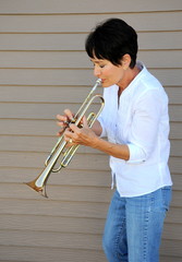 Mature female trumpet player.