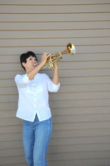 Mature female trumpet player.
