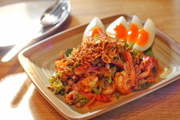 close up thai spicy seafood salad in ceramic dish