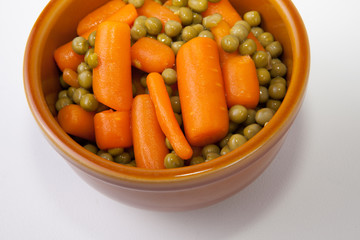 Bowl of boiled carrots and green peas