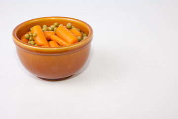 Bowl of boiled carrots and green peas