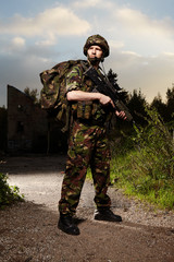 Patrolling soldier in camouflage battle uniform