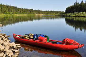Virgin Komi forests, the red boat on the river.