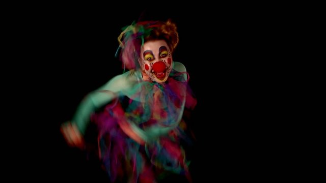 dancing clown with lot of grimaces is having fun