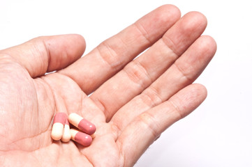 Hand holding a pill capsule.