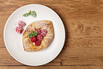 Raspberry pastries with powdered sugar. Selective focus.