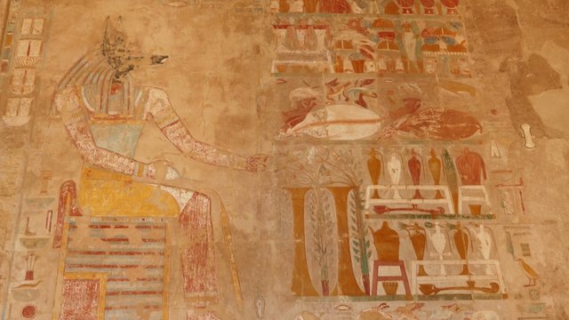 ancient egypt color images on wall in luxor - tilt view 4k