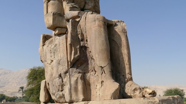 colossi of memnon gigantic statues in Luxor Egypt - tilt view 4k