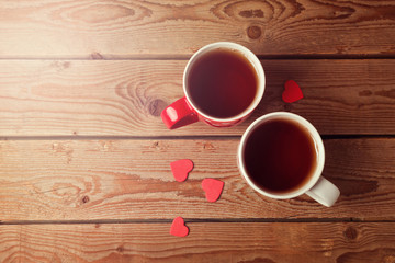 Fototapeta na wymiar Romantic tea cups with heart shape on wooden table