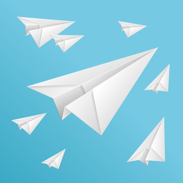 White paper planes on blue sky