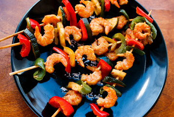 teriyaki shrimps on black plate