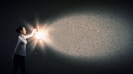 Businesswoman with lantern